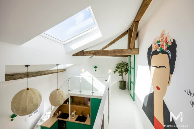 Intérieur loft moderne avec poutres et lumière naturelle.
